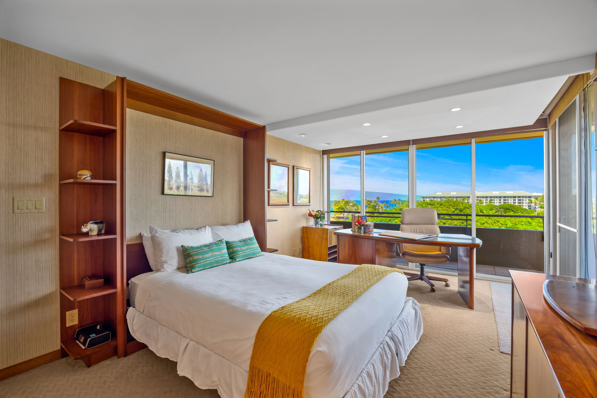 Queen bed and tropical views make this guest bedroom comfortable and inviting.