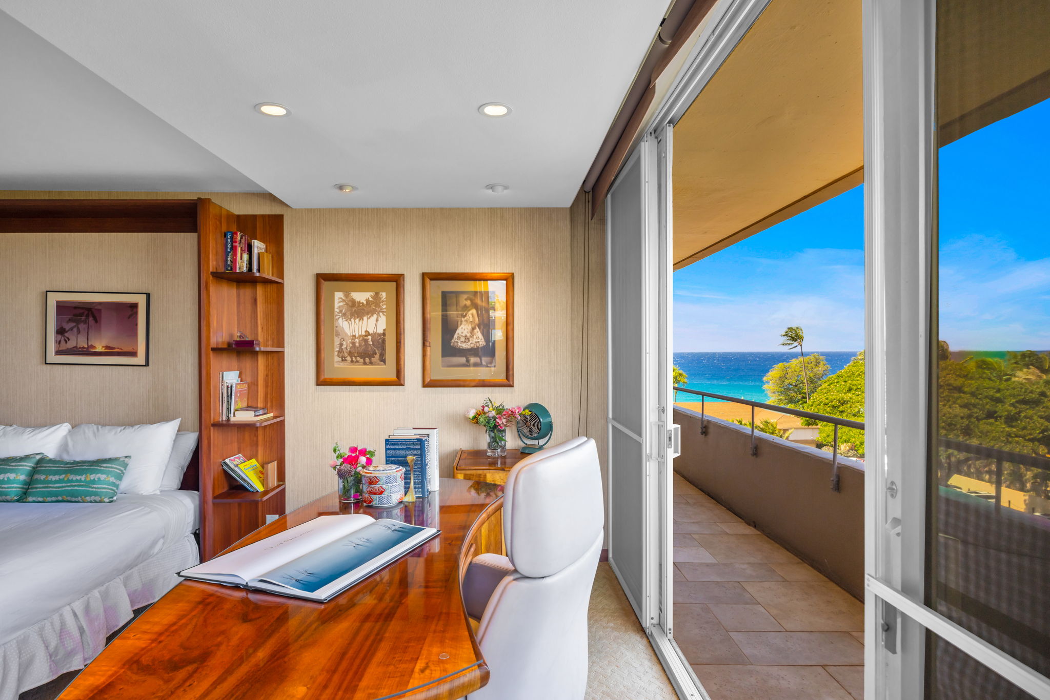 Bright and cozy second bedroom with ocean views and warm natural wood tones.