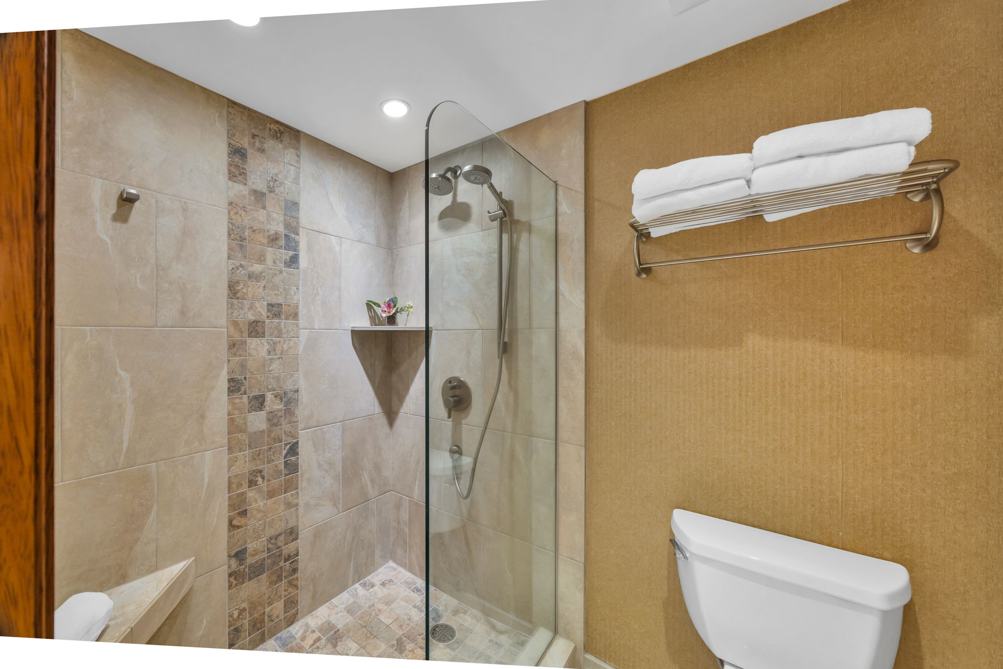 Guest bath with walk-in shower and tiled finishes offers both style and convenience.