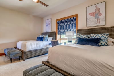 A bold blue palette punctuates the room with modern surf charm, echoing the spirit of the sea