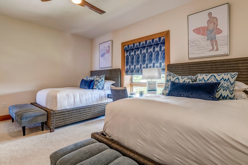 A bold blue palette punctuates the room with modern surf charm, echoing the spirit of the sea