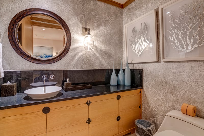 A serene space awaits—complete with a vessel sink, soft lighting, and artisan décor to elevate your daily routine