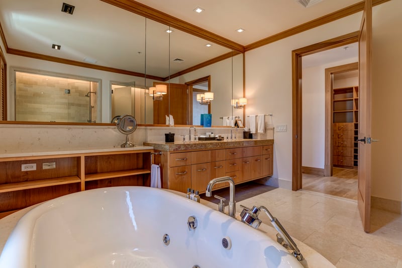 A deep jetted tub awaits like a warm whisper, promising to melt away even the most stubborn travel knots