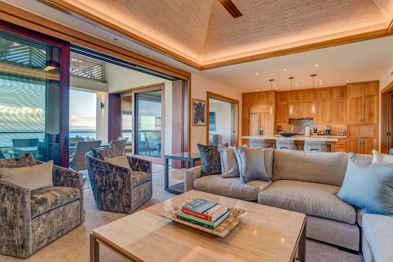 A living room where ceiling fans twirl like palm leaves and rattan baskets secretly store your beachy treasures