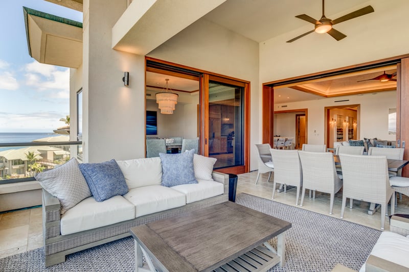 Open-air luxury patio with ocean views and elegant indoor dining.