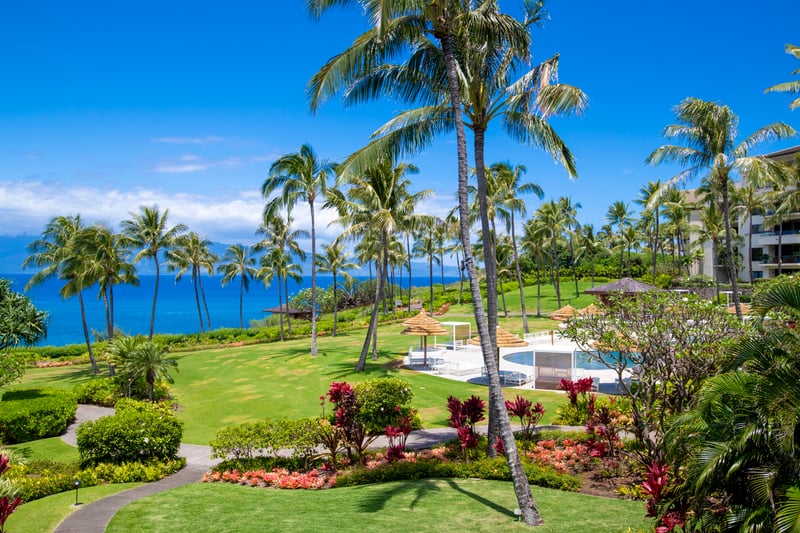 This lanai view sweeps across sculpted lawns and sparkling waves, like a living postcard you’ll never want to leave    