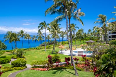 This lanai view sweeps across sculpted lawns and sparkling waves, like a living postcard you’ll never want to leave