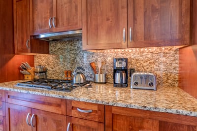 Breakfast dreams bloom where the toaster sits proud, the coffee’s strong, and the backsplash shimmers like lava rock