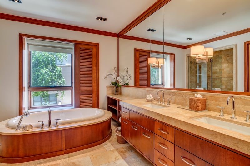 Double vanities, rich cabinetry, and marble counters combine to create a refined symphony of form and function   