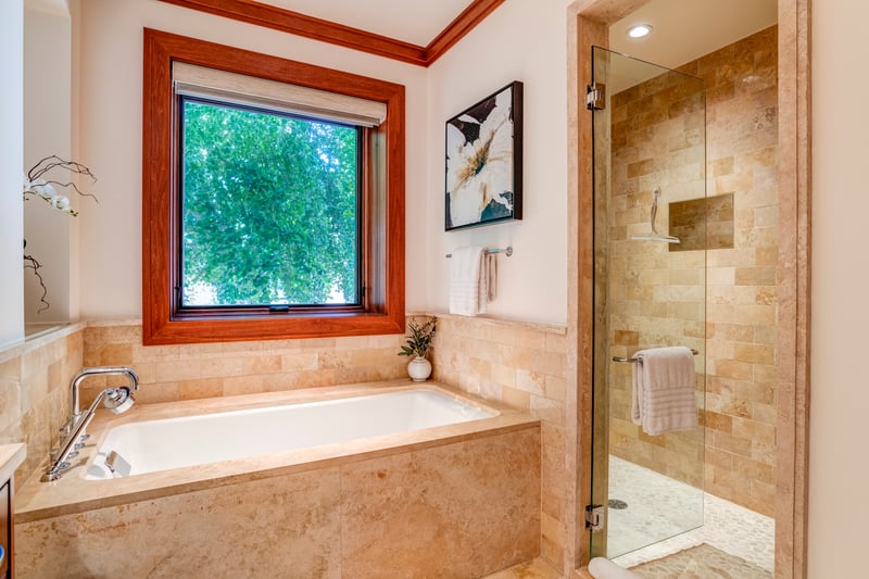 Bathed in natural light and framed by warm wood, this spa-like tub offers a front-row seat to tranquility    