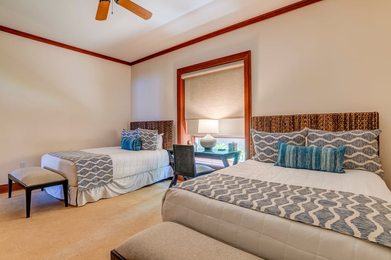 Two queen beds stand side by side like a graceful duet, offering comfort and space in perfect symmetry    