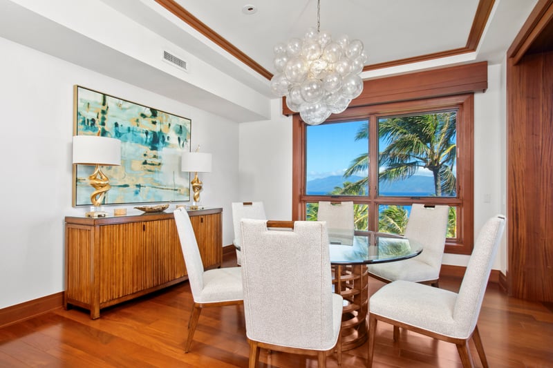  Dine in elegance with panoramic palm-fringed ocean views, modern coastal décor, and golden light pouring through  