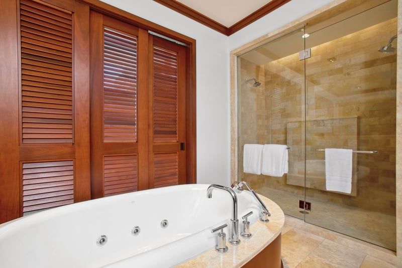 A shower so sleek, even the water flows in hushed admiration—wrapped in golden stone and glassy grace   
