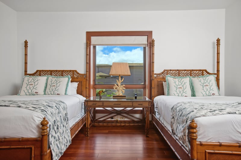   A central window draws the eye with its framed countryside view, offering a tranquil backdrop for serene rest 