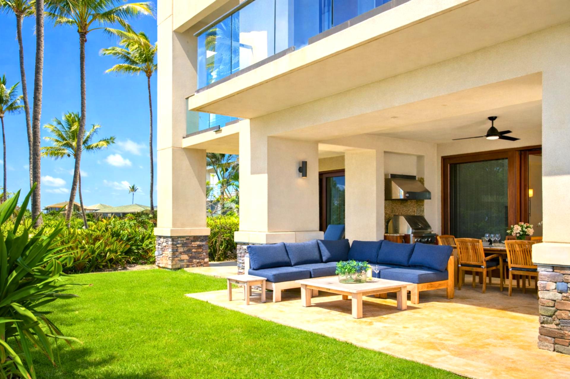 Your covered lanai opens to lush lawn and ocean views, with cushioned seating and ceiling fans for breezy mornings or sunset cocktails.