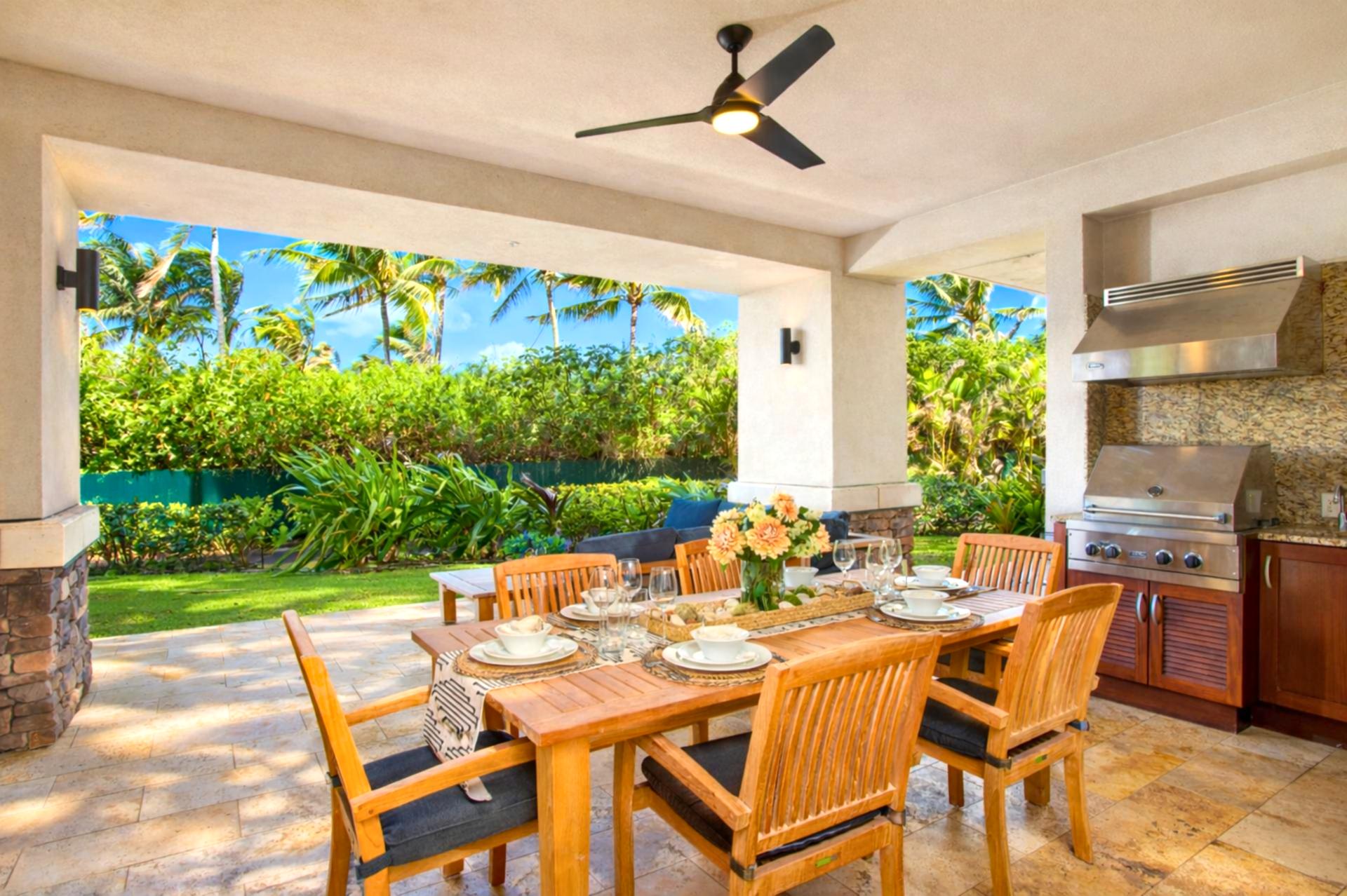 Dine al fresco at your covered lanai table, where ocean views and tropical landscaping create a memorable evening setting.