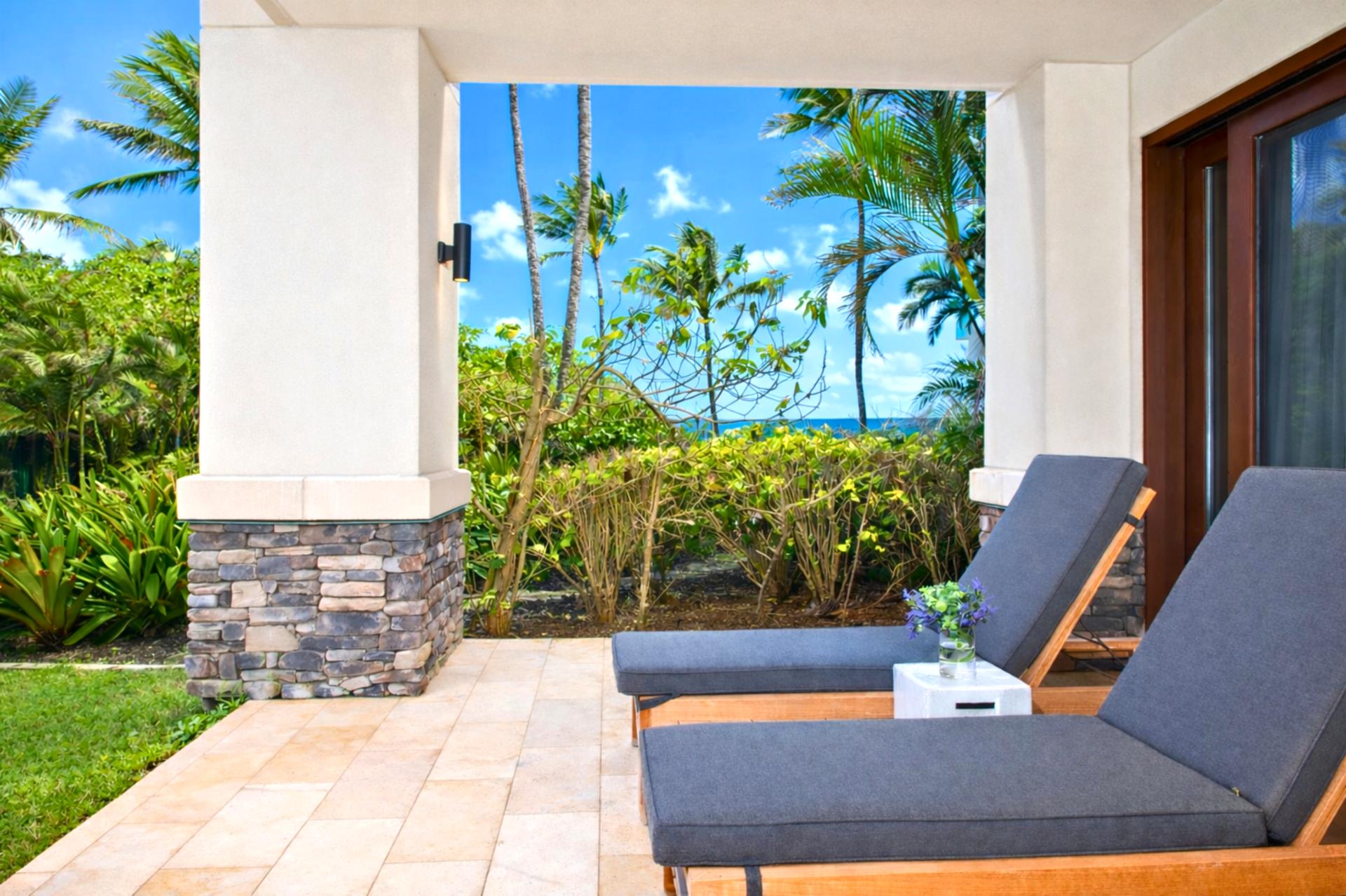 Plush outdoor loungers line your private lanai, offering front row seats to swaying palms and sparkling Pacific views.