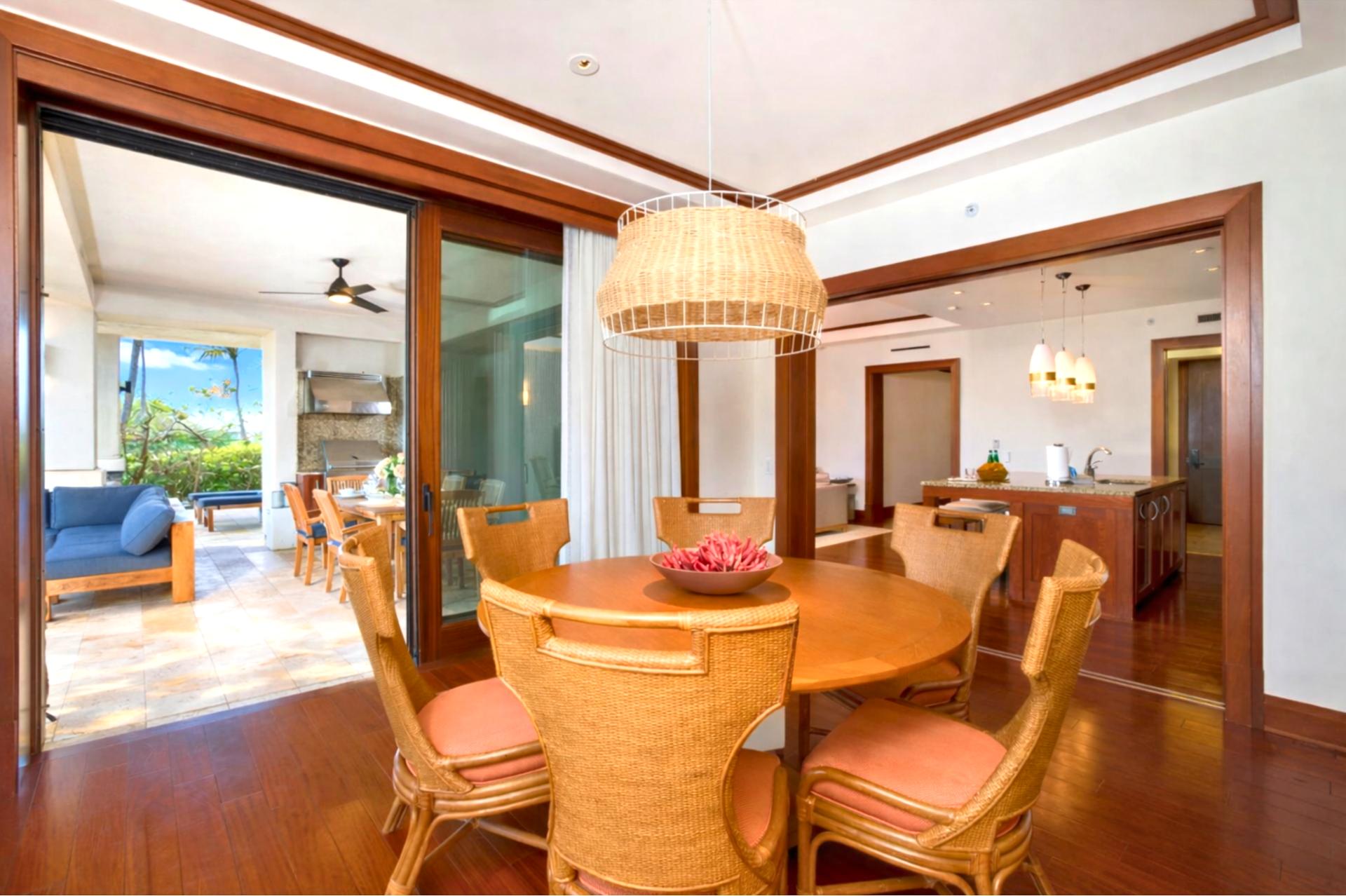 Floor to ceiling glass doors connect your dining area to the lanai, blending indoor comfort with outdoor beauty.