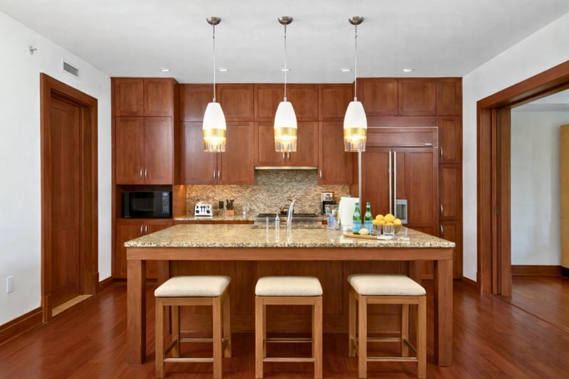 Pendant lighting highlights your expansive kitchen island, with barstools perfectly positioned for coffee or casual meals. MON-2204