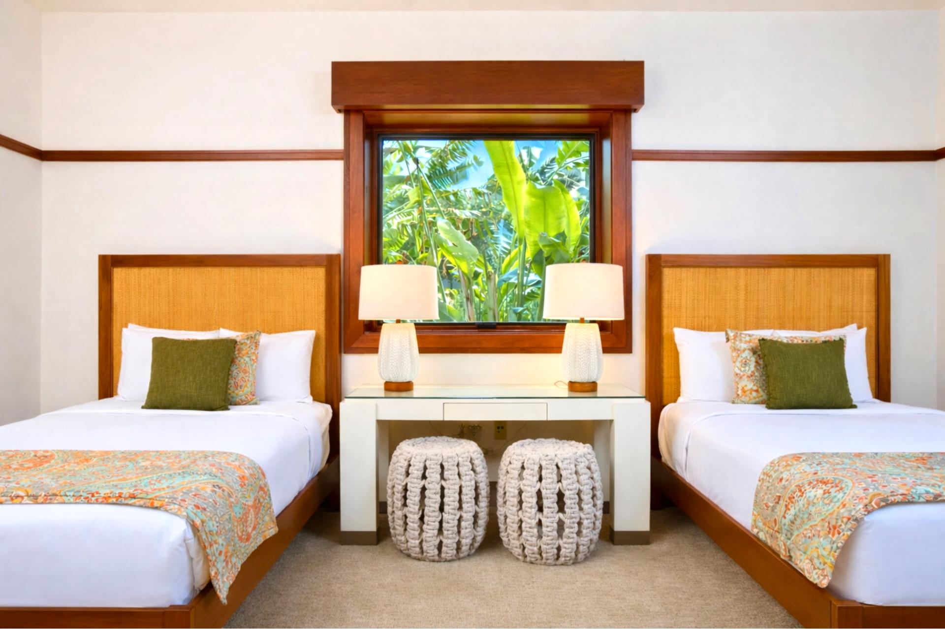 Two beds and a ceiling fan make this guest bedroom comfortable for family or friends traveling together.