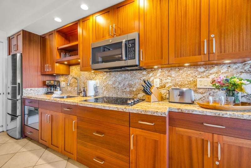 Full kitchen with warm wood cabinetry and sleek appliances.