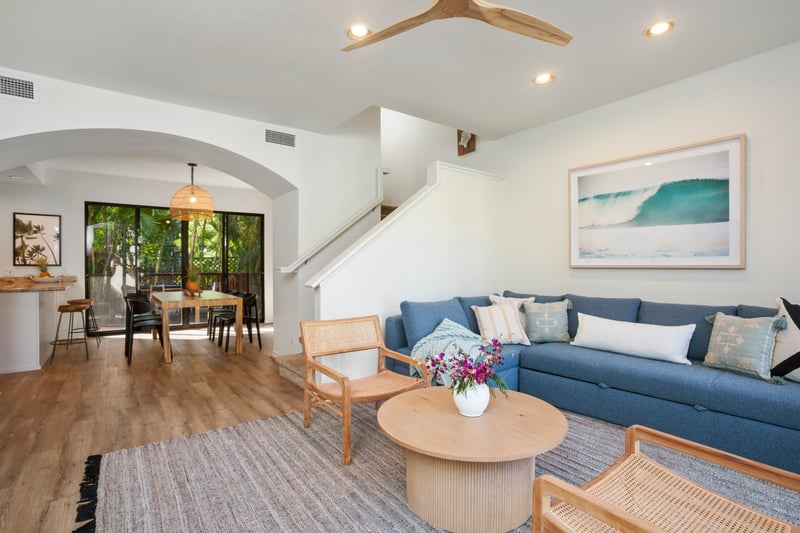 From the rattan armchairs to the ocean-hued sofa, every detail in this living room whispers relaxed coastal luxury