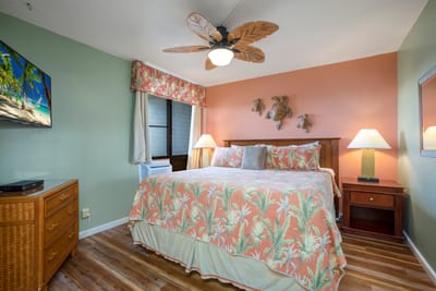 This master suite offers tropical luxury with a cozy king bed, stylish decor, and glowing natural light NAP-A25