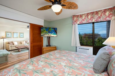 Tropical elegance meets comfort in this serene master suite with garden views, TV, and island decor NAP-A25