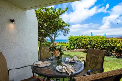 Morning coffee or twilight wine? This floral-topped lanai delivers ocean breezes and a front-row view of aloha NAP-A25