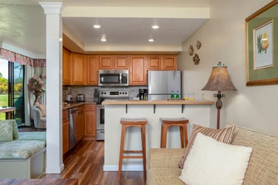 Cook with ease in this inviting kitchen with natural oak tones, bar seating, and thoughtful coastal decor touches NAP-A25