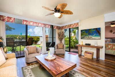 With palm-framed valances, earthy tones, and lanai access, this living room invites leisure with a wink of aloha NAP-A25