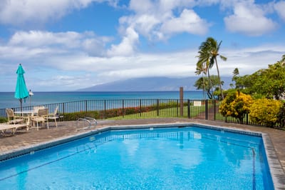 Bask poolside with panoramic ocean views—where tropical comfort meets timeless coastal elegance NAP-A25