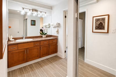 Primary bathroom at Napili Point B31 — a second vanity nook with mirror and natural light for effortless morning routines