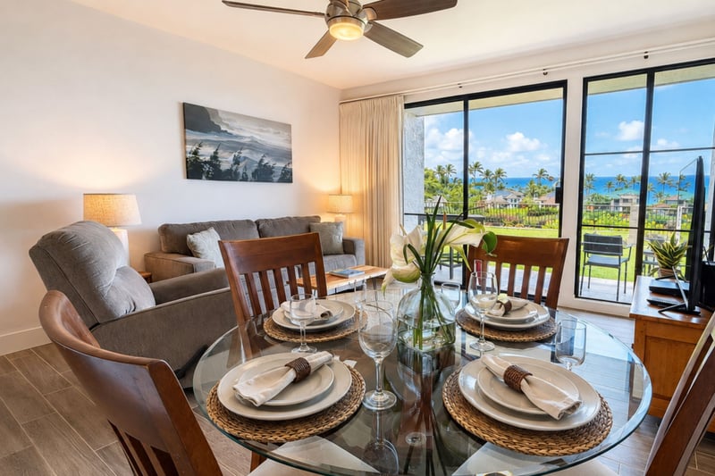 Ocean-view dining at Napili Point B31 — seating for four beside sliding glass doors that open straight to the lanai and the sea beyond