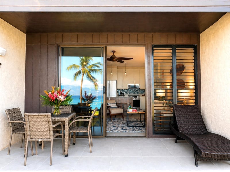 The lanai features a comfortable seating area and chaise lounge for relaxing