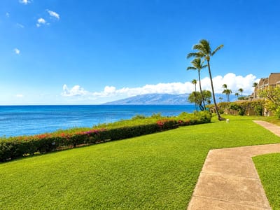 Spacious lawn leading to coastline with stunning island views