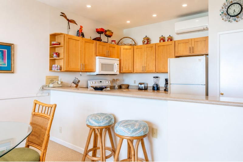 Fully equipped kitchen featuring a breakfast bar with seating—perfect for a quick morning bite before hitting the beach.