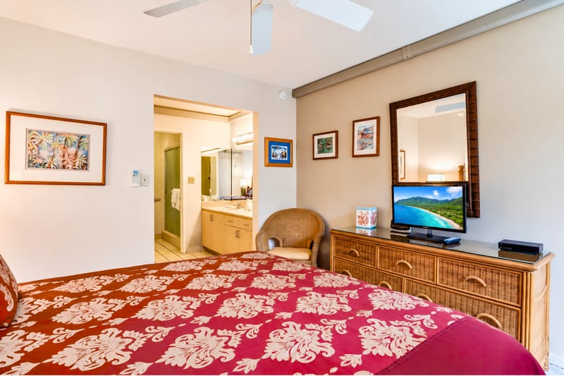 The primary suite features ample storage, a flat-screen TV, and easy access to your private en-suite bathroom.