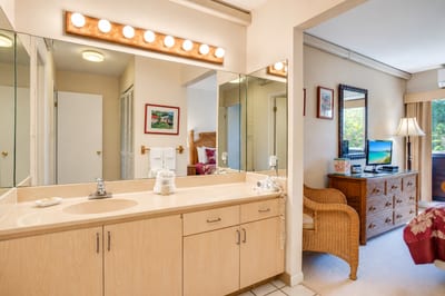 Bright and clean master bathroom vanity with plenty of counter space and excellent lighting to get ready for dinner in Kapalua.