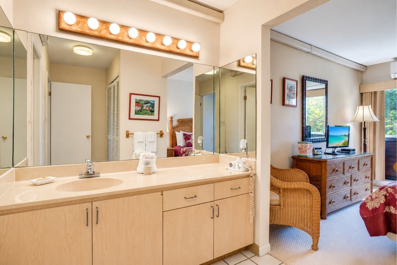 Bright and clean master bathroom vanity with plenty of counter space and excellent lighting to get ready for dinner in Kapalua.