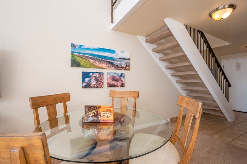 This sunny dining space offers lofted ceilings, modern tropical decor, and a cozy spot to enjoy meals and moments NAP-C18