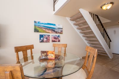 This sunny dining space offers lofted ceilings, modern tropical decor, and a cozy spot to enjoy meals and moments NAP-C18