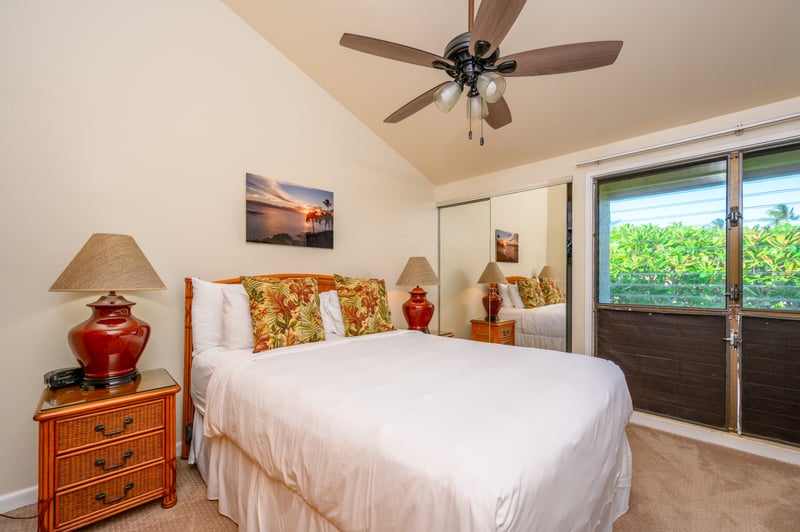Master bed room with warm rattan furnishings, soft lighting, mirrored closet, and sliding barn door for added charm NAP-C18