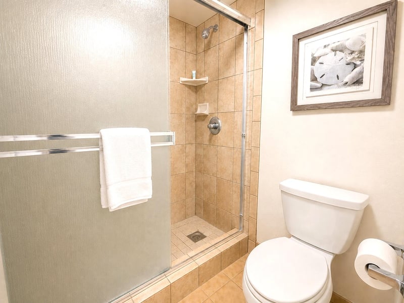 The guest bathroom features a walk in shower and elegant tile finishes