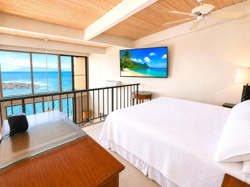 The guest loft bedroom features a comfortable bed and gorgeous ocean views  NAP-C19