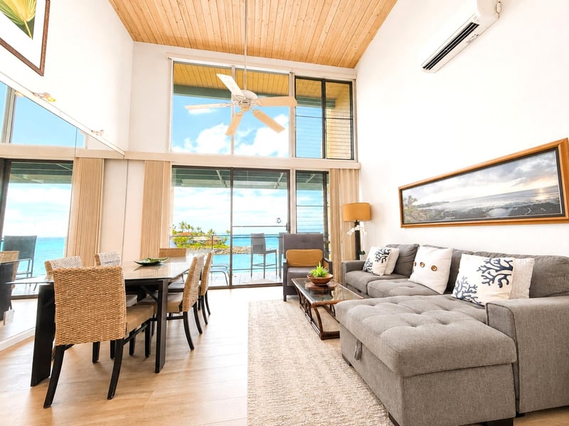 A spacious living room with warm natural light and an easy flow to the lanai NAP-C19
