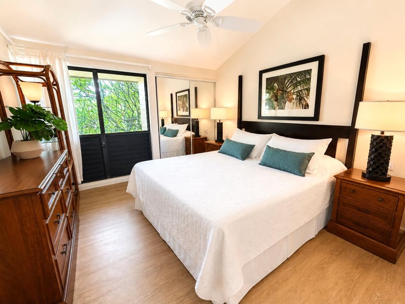 The primary bedroom offers a restful retreat with warm bedding and soft afternoon light NAP-C19
