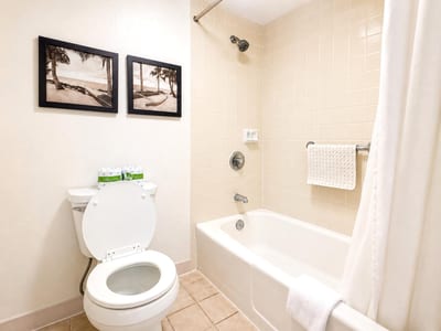 The primary bath is neatly finished with a tub and everything guests need for a comfortable stay