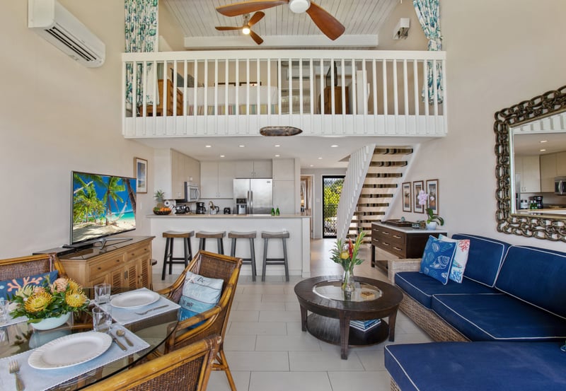 Lofty island living awaits with breezy rattan charm, ocean-blue accents, and a modern kitchen that shines bright