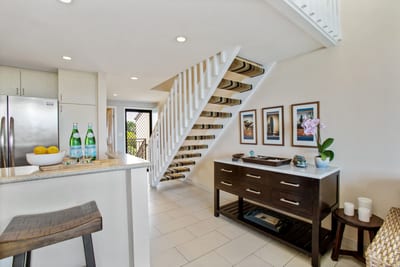 Enjoy cooking in this bright, modern kitchen with stainless steel appliances, sleek stone counters, and soft lighting